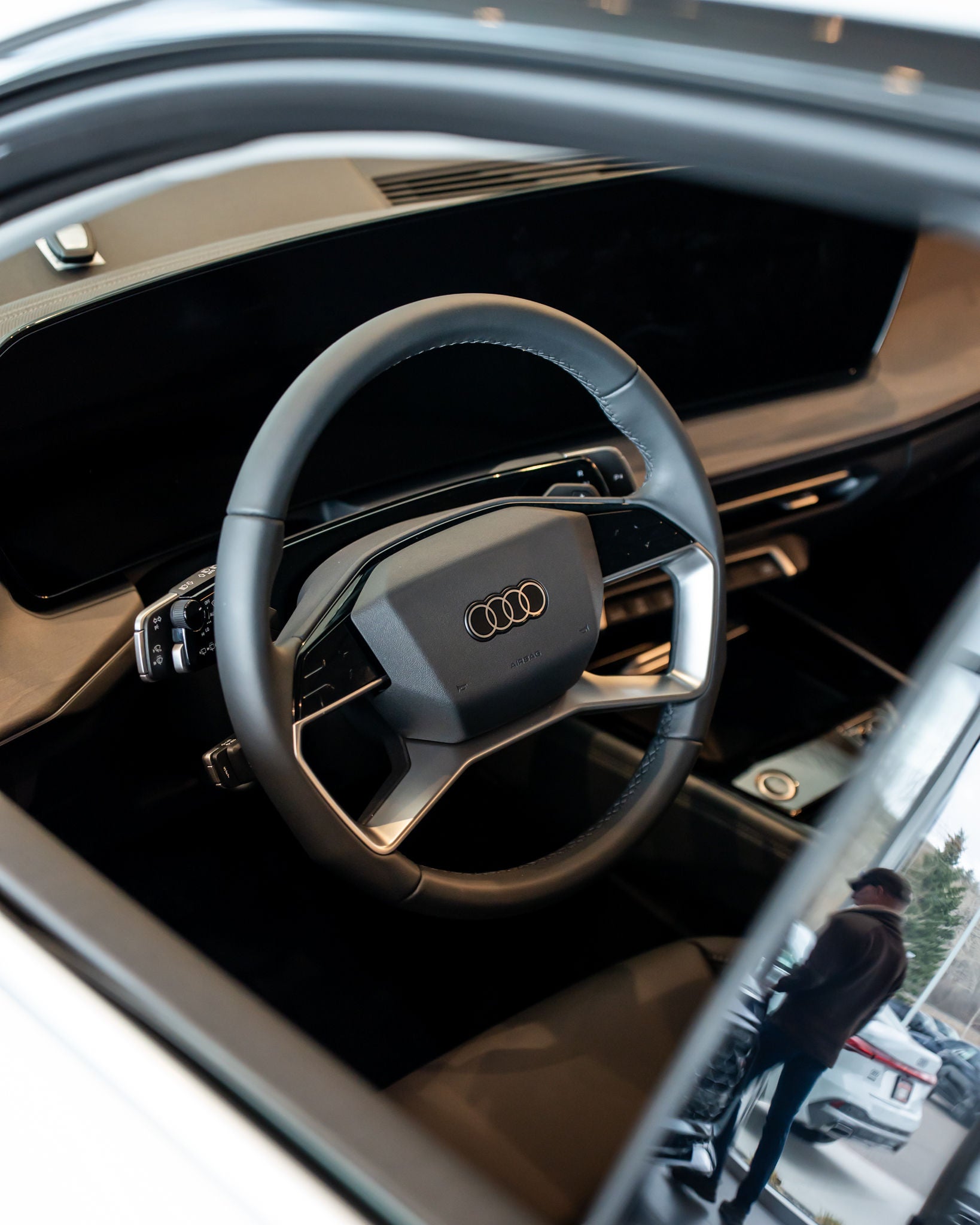 Q3 driver side window view of steering wheel and interior dashboard
